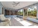 Light-filled sunroom featuring tile flooring, ceiling fan, and large windows at 927 Lemon Bay Dr, Venice, FL 34293