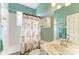 The bathroom features a shower-tub combo, a white vanity and neutral tiling at 13324 Purple Finch Cir, Lakewood Ranch, FL 34202