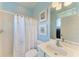 The bathroom features a shower-tub combo, a white vanity, and blue walls at 13324 Purple Finch Cir, Lakewood Ranch, FL 34202