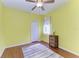 Simple bedroom features laminate floors, a ceiling fan, and a large window at 13324 Purple Finch Cir, Lakewood Ranch, FL 34202