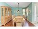 An open dining room features wood floors and a wooden table and chairs at 13324 Purple Finch Cir, Lakewood Ranch, FL 34202