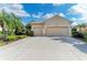 Exterior shot showing a house with a spacious three-car garage and well-manicured landscaping at 13324 Purple Finch Cir, Lakewood Ranch, FL 34202