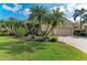 Well maintained home featuring a three car garage and lush tropical landscaping and manicured lawn at 13324 Purple Finch Cir, Lakewood Ranch, FL 34202
