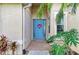 Charming home exterior showcasing a blue front door with decorative wreath and lush foliage at 13324 Purple Finch Cir, Lakewood Ranch, FL 34202