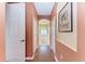 Hallway view leads to a bathroom with a soaking tub and shutters at 13324 Purple Finch Cir, Lakewood Ranch, FL 34202