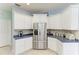 The bright kitchen includes stainless steel appliances, a breakfast bar, and white cabinets at 13324 Purple Finch Cir, Lakewood Ranch, FL 34202