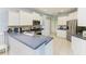 Bright kitchen featuring white cabinetry, stainless steel appliances, and a blue countertop at 13324 Purple Finch Cir, Lakewood Ranch, FL 34202