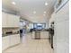 An open kitchen features white cabinets, stainless steel appliances, and tile flooring at 13324 Purple Finch Cir, Lakewood Ranch, FL 34202