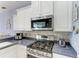 The well-lit kitchen provides stainless steel appliances and a gas range at 13324 Purple Finch Cir, Lakewood Ranch, FL 34202