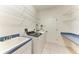Well organized laundry room with overhead shelving, a utility sink and a modern washer/dryer at 13324 Purple Finch Cir, Lakewood Ranch, FL 34202