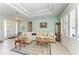 Comfortable living room featuring tray ceilings, neutral decor, and natural light at 13324 Purple Finch Cir, Lakewood Ranch, FL 34202