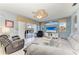 An airy living room is styled with comfortable seating, tile floors, and a ceiling fan at 13324 Purple Finch Cir, Lakewood Ranch, FL 34202