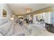 A comfortable living room offers tile floors, comfortable seating, and access to the patio at 13324 Purple Finch Cir, Lakewood Ranch, FL 34202