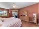 Relaxing main bedroom with natural wood furniture, ceiling fan, and access to lanai at 13324 Purple Finch Cir, Lakewood Ranch, FL 34202