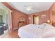 Comfortable bedroom with wood floors and slider access to the outdoor lanai at 13324 Purple Finch Cir, Lakewood Ranch, FL 34202