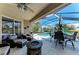 Inviting screened patio with a fire pit, comfortable seating, and views of the pool and serene lake at 13324 Purple Finch Cir, Lakewood Ranch, FL 34202