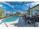 The beautiful pool with a screened enclosure offers lovely lake views and outdoor seating for entertaining at 13324 Purple Finch Cir, Lakewood Ranch, FL 34202