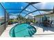 Enjoy the screened-in pool area with comfortable seating, perfect for relaxing while overlooking the lake at 13324 Purple Finch Cir, Lakewood Ranch, FL 34202