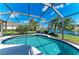 Sparkling pool is enclosed by screen with a lush backyard that overlooks the beautiful community lake at 13324 Purple Finch Cir, Lakewood Ranch, FL 34202