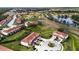Aerial view of townhouses with red roofs and well-manicured landscaping around a pond at 2345 Felicity Pl, North Port, FL 34289