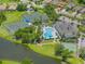 Aerial view of community pool, tennis and bocce ball courts with lake views at 2345 Felicity Pl, North Port, FL 34289