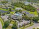 Aerial view of community clubhouse, pool, tennis courts and parking area at 2345 Felicity Pl, North Port, FL 34289