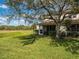 Scenic backyard view with green grass, shady trees, and views of neighboring landscape at 2345 Felicity Pl, North Port, FL 34289