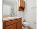 Bathroom featuring wood cabinets, light countertops, toilet and a round sink at 2345 Felicity Pl, North Port, FL 34289