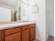 Bathroom featuring light countertops, wooden cabinets, decorative accents, and walk-in shower at 2345 Felicity Pl, North Port, FL 34289
