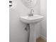 Bright bathroom featuring a pedestal sink, stylish faucet, and modern lighting fixtures at 2345 Felicity Pl, North Port, FL 34289
