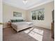 Bright bedroom with tray ceiling, plush carpet and views of the outdoors at 2345 Felicity Pl, North Port, FL 34289
