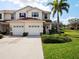 Inviting townhome with lush landscaping, attached two-car garage and beautiful curb appeal at 2345 Felicity Pl, North Port, FL 34289