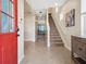 Welcoming foyer with tile flooring, staircase and archway leading to the open-concept living area at 2345 Felicity Pl, North Port, FL 34289