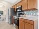 Modern kitchen showcasing stainless steel appliances, tile backsplash, and wooden cabinetry at 2345 Felicity Pl, North Port, FL 34289