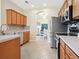 Well-equipped kitchen with stainless steel appliances, tile flooring, and ample counter space at 2345 Felicity Pl, North Port, FL 34289