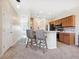 Well-lit kitchen area with modern appliances, barstool seating and adjacent living area at 2345 Felicity Pl, North Port, FL 34289