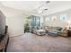Bright living room leading to an outdoor patio through sliding glass doors and sheer curtains at 2345 Felicity Pl, North Port, FL 34289
