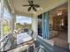 Relaxing patio with stylish furniture and ceiling fan next to sliding glass doors at 2345 Felicity Pl, North Port, FL 34289