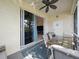 Outdoor patio with table and chairs adjacent to grassy outdoor area at 2345 Felicity Pl, North Port, FL 34289