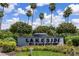 Lakeside Plantation sign amidst lush landscaping with flowers and palm trees at 2345 Felicity Pl, North Port, FL 34289