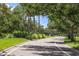 A street lined with trees in a residential neighborhood with a speed limit sign at 2345 Felicity Pl, North Port, FL 34289