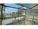 Screened-in balcony offering serene water views and comfortable outdoor dining space at 4234 Gulf Of Mexico Dr # E2, Longboat Key, FL 34228