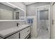 Modern bathroom features a large, illuminated mirror over the sleek vanity at 4234 Gulf Of Mexico Dr # E2, Longboat Key, FL 34228