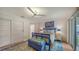 Inviting bedroom featuring a blue-framed bed, wood flooring, and a sliding glass door with waterfront view at 4234 Gulf Of Mexico Dr # E2, Longboat Key, FL 34228