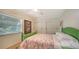 Bright bedroom with a floral bedspread, a ceiling fan, and sliding closet doors at 4234 Gulf Of Mexico Dr # E2, Longboat Key, FL 34228
