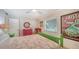 Cozy bedroom with colorful furniture, a ceiling fan, and natural light at 4234 Gulf Of Mexico Dr # E2, Longboat Key, FL 34228