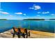 Tranquil water views with a bench on the community dock overlooking the water at 4234 Gulf Of Mexico Dr # E2, Longboat Key, FL 34228
