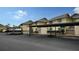 Exterior view of condo buildings with covered parking and well-maintained landscaping at 4234 Gulf Of Mexico Dr # E2, Longboat Key, FL 34228