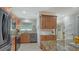 Updated kitchen featuring stainless steel appliances, granite countertops, and warm wood cabinetry at 4234 Gulf Of Mexico Dr # E2, Longboat Key, FL 34228
