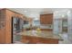 A well-appointed kitchen featuring granite countertops, a central island, stainless appliances, and wood cabinetry at 4234 Gulf Of Mexico Dr # E2, Longboat Key, FL 34228